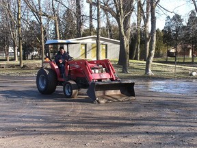 Municipality of Chatham-Kent employee Steve Lawton was at Thames Grove Conservation Authority on Tuesday scraping the silt and mud left behind when the Thames River receded after a weekend flood. Ellwood Shreve/Postmedia Network