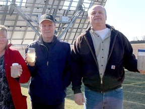 Chatham Township residents, from left, Angie and Jim Leveille and Rick Goetheyn, are shown on Tuesday displaying samples of dirty water coming out of the wells on their properties just days after turbines with the North Kent Wind farm began operating. Ellwood Shreve/Postmedia Network