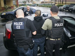 In this Tuesday, Feb. 7, 2017 photo released by U.S. Immigration and Customs Enforcement, foreign nationals are arrested during a targeted enforcement operation conducted by ICE aimed at immigration fugitives, re-entrants and at-large criminal aliens in Los Angeles. Charles Reed / U.S. Immigration and Customs Enforcement via AP