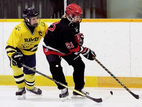 Northern Vikings' Leah Williams (21) is pressured by Chatham-Kent Golden Hawks' Payton Sabourin (4) in the third period of the LKSSAA AAA girls' hockey final at Erickson Arena in Chatham, Ont., on Wednesday, Feb. 28, 2018. (Mark Malone/Postmedia Network)