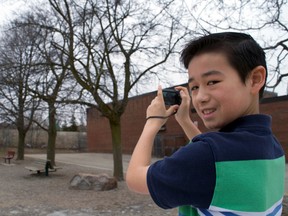 Grade 7 student Juno Flath snaps a photo outside Masonville public school. Flath and his classmates recently experienced a London Arts Council program called Culture City and even raised some money for Ark Aid Street Mission. (CHRIS MONTANINI\LONDONER)