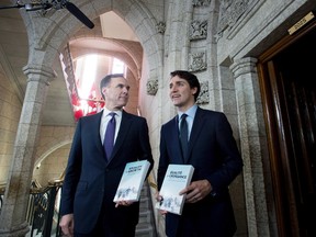 Minister of Finance Bill Morneau walks with Prime Minister Justin Trudeau before tabling the budget in the House of Commons on Parliament Hill in Ottawa. (CANADIAN PRESS)