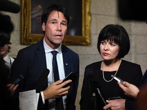 Minister of Health Ginette Petitpas Taylor stands with Eric Hoskins, former Ontario Minister of Health, after the tabling of the budget in the House of Commons on Parliament Hill in Ottawa on Tuesday, Feb. 27, 2018. Hoskins will chair a federal government advisory council to implement a national pharmacare plan. THE CANADIAN PRESS