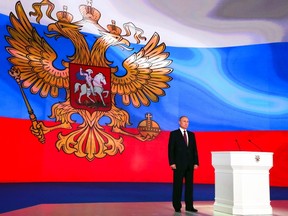 Russian President Vladimir Putin stands after giving his annual state of the nation address in Manezh in Moscow, Russia, Thursday, March 1, 2018. (Mikhail Klimentyev, Sputnik, Kremlin Pool Photo via AP)