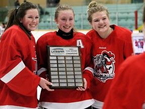 Ashley Kucera, left, Lyndsi Hull and Maddy Leliveld of the Lambton Central Lancers pose for a photo after beating the Wallaceburg Tarans 1-0 in the LKSSAA 'A-AA' girls' hockey final at Wallaceburg Memorial Arena in Wallaceburg, Ont., on Thursday, March 1, 2018. (Mark Malone/Chatham Daily News/Postmedia Network)