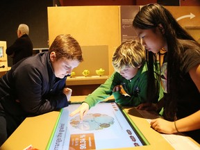 Princess Anne Public School students Nicholas Gauthier, left, Jordan Marchand and Verna Junio examine an exhibit at  Engineering Earth, a travelling exhibition at Dynamic Earth in Sudbury on Thursday. The exhibition, which opens to the public on March 3, features interactive exhibits and hands-on experiences that will show visitors the potential of grains, soils, clay, mud, and sand in the use of green construction. John Lappa/Sudbury Star/Postmedia Network