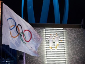 Torchbearers carry the Olympic torch during the opening ceremony of the Pyeongchang 2018 Winter Olympic Games at the Pyeongchang Stadium on February 9, 2018. / AFP PHOTO / Odd ANDERSENODD ANDERSEN/AFP/Getty Images