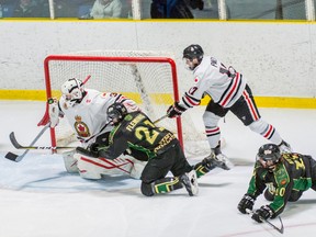 Sarnia Legionnaires goalie Will Barber bats a loose puck out of harm's way Thursday in a Jr. 'B' hockey playoff game won 3-1 by the St. Thomas Stars. Stars forward Peter Fleming is shown on his nears, striving to reach the disc. (Submitted photo by Shawna Lavoie)