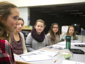 Olivia Floris, left, speaks during a Girls in Government meeting with 13-year-olds Adria Gioiosa, Kennedi Knoch, Venus Osmani and Amber Pridoehl at St. Paul Catholic elementary school in London this week. (MIKE HENSEN, The London Free Press)