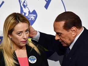 Leader of Italian right-wing party Forza Italia Silvio Berlusconi, right embraces Giorgia Meloni, president of Brothers of Italy party, at the end of a joint press conference in Rome on Thursday. (ALBERTO PIZZOLI/AFP/Getty Images)