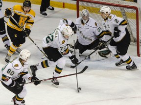London Knights' Alec Regula redirects the puck away from goaltender Jordan Kody, with teammates Alex Formenton, Evan Bouchard with Kingston Frontenacs' Jakob Brahaney giving chase during the first period of Ontario Hockey League action at the Rogers K-Rock Centre in Kingston, Ont. on Friday, March 2, 2018. (JULIA MCKAY/Postmedia Network)