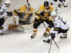 London Knights’ Nathan Dunkley tries to redirect the puck past Kingston Frontenacs’ Jacob Paquette and goaltender Jeremy Helvig during the first period of Ontario Hockey League action at the Rogers K-Rock Centre in Kingston, Ont., on Friday, March 2, 2018. (Julia McKay/The Whig-Standard/Postmedia Network)