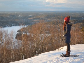 Alyssa Short takes in the view from the 500-metre (above sea level) hill hosting the Cascaden fire tower. That’s Windy Lake down below, including Birch Island. (Jim Moodie/The Sudbury Star)