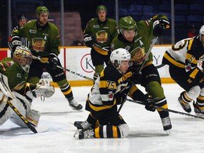 North Bay Battalion defenceman Adam Thilander (3) battles Kingston Frontenacs forward Linus Nyman (75) for a loose puck during the first period of OHL action at Memorial Gardens, Sunday. Dave Dale / The Nugget