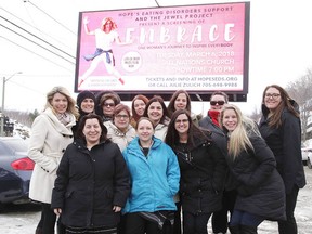 Julie Zulich and her employees under a billboard for the movie Embrace, a documentary that promotes positive body image. The film screens at All Nations Church on Tuesday at 7 p.m. (Gino Donato/Sudbury Star)
