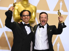 Dan Cogan, left, and Bryan Fogel, winners of the award for best documentary feature for "Icarus" pose in the press room at the Oscars on Sunday, March 4, 2018, at the Dolby Theatre in Los Angeles. (Photo by Jordan Strauss/Invision/AP)