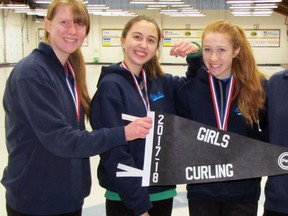 The Mitchell District High School (MDHS) girls ‘A’ curling team of Kelly Ward (left), Aisha Montano Guitierrez, Bree Belfour and Myah Vingerhoeds pose with their Perth championship banner and their silver medals from the Huron-Perth bonspiel Feb. 26. Absent was Randi Shuker. SUBMITTED