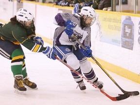Jordan Heffern of the Lockerby Vikings battles for the puck with Hanna Smith of the Lo-Ellen Park Knights during the girls N.O.S.S.A. championships in Sudbury, Ont. on Monday March 5, 2018. Gino Donato/Sudbury Star/Postmedia Network