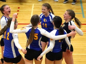 Hannah Petcoff of Oakridge drives a spike down the line past the block of Grace Mazur and Babelonea Hawel of St. Jean de Brebeuf during their Pool C game at the OFSAA AAA girls volleyball championship at Oakridge on Monday. The host school won 25-23, 25-22. (Mike Hensen/The London Free Press)