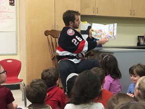 BRUCE BELL/THE INTELLIGENCER
Belleville Senator Ben Sexton reads to kindergarten to Grade 2 students at St. Gregory Catholic School in Picton on Tuesday afternoon. Sexton, along with teammates Daniel Ciampini and Marcus Hogberg, dropped into the school for a reading and question-and-answer period.