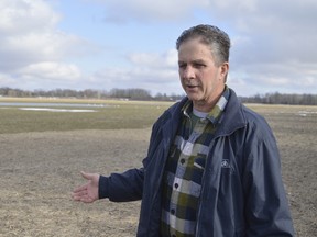 Dave Sherman stands on his farm near Thamesville, Ontario. He was one of the farmers most affected by regional flooding in late February, flooding that could cost his operation thousands of dollars in lost yield. (Louis Pin // Times-Journal)