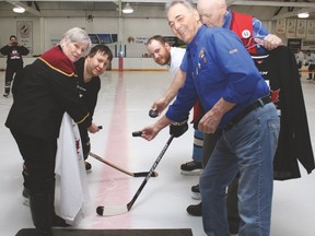 The 24-hour hockey fundraiser for the Vulcan pool project was held Friday and Saturday at the Vulcan District Arena. The game started off with a puck drop Friday evening between Chris Gauthier of the black team and Jordan Krystalowich of the white team. Vulcan Town Councillor Georgia-Lee DeBolt and Vulcan Lions Club members Alcide Cloutier, front right, and Tom Wylie took part in the puck drop. Jasmine O'Halloran Vulcan Advocate