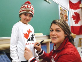 Canadian Olympic athlete Rebecca Johnston, of Sudbury, autographs a jersey for Keira Bertrand, 9, at Algonquin Road Public School in Sudbury, Ont. on Tuesday March 6, 2018. The Three-time Olympian, who played on the Canadian Women's hockey team, shared her experiences and answered questions from Grade 4 students during her visit to the school. Johnston has won two gold and one silver medal with the Canadian women's Olympic hockey team. John Lappa/Sudbury Star/Postmedia Network