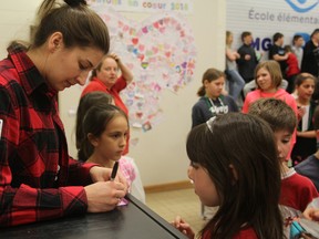 Olympic gold and silver medallist Genevieve Lacasse, goalie for the Canadian women's hockey team, visits her old elementary school Mgr-Rémi-Gaulin in Kingston on Tuesday. (Steph Crosier/The Whig-Standard)