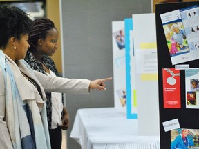 Melissa Bilek and Alice Farley look at the displays set up at the John D. Bradley Centre for the Chatham-Kent Health Alliance's nursing job fair on March 6. (Tom Morrison/Chatham This Week)