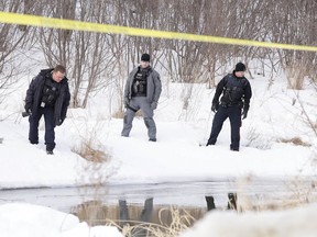 Investigators comb the shore of Lily Creek off Beverly Drive Monday after a body was found in the water. (Gino Donato/Sudbury Star)