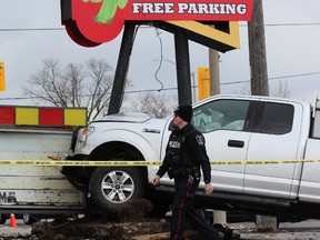 Police arrested a man after a stolen pickup truck slammed into a sign outside Under the Volcano, a Mexican restaurant at 30 Wharncliffe Rd., just south of Riverside Drive, around 11:30 a.m. Wednesday. (DALE CARRUTHERS / THE LONDON FREE PRESS)