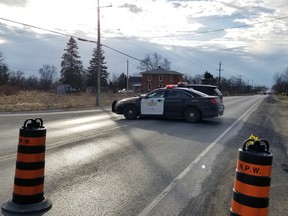 Ontario Provincial Police cruisers block Highway 2 at Switzerville Road in Napanee following a collision that killed a Napanee woman and sent another man to hospital. (Cris Vilela/For The Whig-Standard)
