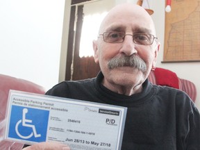 Mike Dunn poses with his accessible parking sticker. The Sarnia man is hoping the City of Sarnia will expand a new program that lets people with the stickers park free for two hours in accessible spaces in municipal lots. Tyler Kula/Sarnia Observer/Postmedia Network