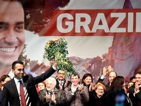 Italy's populist Five Star Movement (M5S) party leader Luigi Di Maio (L) waves flowers as he celebrates with supporters in his home town of Pomigliano on March 6, 2018, after Italy's general elections. The anti-establishment Five Star Movement and the far-right euro-sceptic League party were the big winners of the election. / AFP PHOTO / Alberto PIZZOLIALBERTO PIZZOLI/AFP/Getty Images