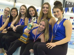 Synchronized swimmers Alex Hicks, Lily Dong, Kathryn Shiplo, Suzie Blainey, Olivia Jantzie, and Julie Villeneuve hold Kyra Moura who holds the trophy the team won at the national championships held February 18th at Brock University. The swimmers, all Western students were the only non-university affiliated team of the 15 that took part and still won in only their fourth year of existence. (Mike Hensen/The London Free Press/Postmedia Network)