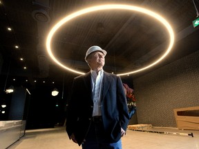 David Terry, vice-president of the Rec Room division of Cineplex, stands under a ring light measuring more than four metres in diameter that decorates the lobby of the new adult play space under construction at Masonville Place mall. The attraction is set to open April 30. (MORRIS LAMONT/THE LONDON FREE PRESS)