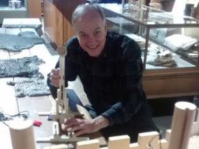 Mike Baker, Elgin County Museum curator, takes aim with mini catapult at a model castle - a hands-on part of the current exhibition of Medieval European life at Elgin County Heritage Centre and one of a number of March break things to see and do in St. Thomas and Elgin. (Eric Bunnell/Times-Journal)