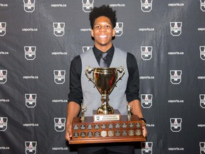 Laurentian Voyageurs guard Kadre Gray poses with the Mike Moser Memorial Trophy, given to the USports player of the year. USports photo
