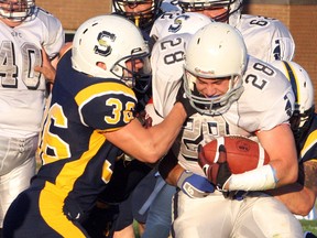 Sault Steelers' Justin Sauerzopf gets hold of Sudbury Spartans' Josh Cuomo during Northern Football Conference action at Queen's Athletic Field in Sudbury in this 2012 file photo. Ben Leeson/The Sudbury Star/Postmedia Network