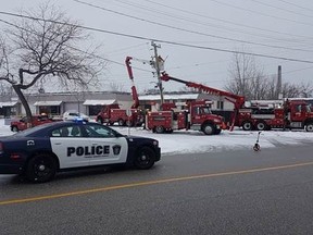 A photo provided by Sarnia police shows repairs being made to a hydro pole next to Confederation Street in Sarnia following an early-morning single vehicle collision Friday that sent a driver to hospital in serious condition. (Handout/The Observer)