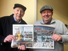 Bill Hackett, left, and Garry McColman, co-chairs of   the 21st annual KIds For Kids Hockey Tournament with the 2017 tournament program in KIngston on Wednesday March 7 2018. Ian MacAlpine/Kingston Whig-Standard/Postmedia network