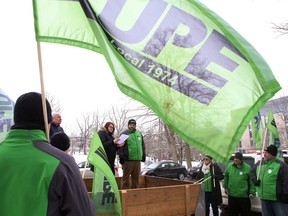 Mike Rodrigues, president of Canadian Union of Public Employees Local 1974 and worker Carri Hannah speak to union members during a rally in front of Kingston Health Sciences Centre in Kingston, Ont. on Friday, March 9, 2018. 
Elliot Ferguson/The Whig-Standard/Postmedia Network