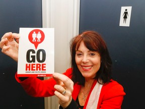 Luke Hendry/The Intelligencer
Cathy Robichaud, the Belleville-area's volunteer ambassador of Crohn's and Colitis Canada, holds the logo of the charity's "GoHere" campaign Friday. The GoHere mobile device application maps the location of public washrooms. Robichaud is asking businesses and other public spaces to register to the app, which also includes links' to participants' websites.
