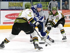 Alexey Lipanov, middle, of the Sudbury Wolves, attempts to evade Travis Mailhot, left, and Nick King, of the North Bay Battalion, during OHL action at the Sudbury Community Arena in Sudbury, Ont. on Friday March 9, 2018. John Lappa/Sudbury Star/Postmedia Network