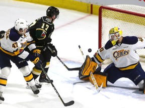 Nathan Dunkley of the Knights looks for a rebound as Erie goalie Anand Oberoi gets a blocker on the puck as Owen Hendrick of the Otters tries to tie up Dunkley during their Friday night game at Budweiser Gardens on March 9, 2018. The Knights lead 1-0 on a goal by Richard Whittaker. Mike Hensen/The London Free Press