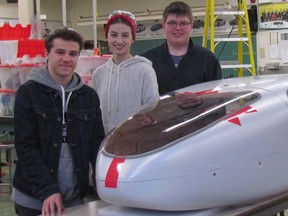 From left, Ethan Paulley, 17,  Maria Peregoudov, 18 and Jared Waller, 17, are shown  Sunday with the shell of the Northern Collegiate Eco Team vehicle set to complete in April in the Shell Eco-marathon at Somoma, California.
 Paul Morden/Sarnia Observer/Postmedia Network