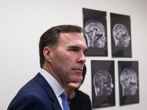 Finance Minister Bill Morneau takes a tour of the Brain Behaviour Laboratory at the University of British Columbia March 6. He and the Liberal government are battling some big political headaches these days. (DARRYL DYCK / THE CANADIAN PRESS)