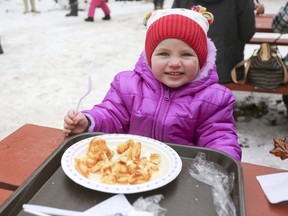 Two-year-old Clara Martelle enjoyed some homemade pancakes on Saturday at Little Cataraqui Creek Conservation Area during Maple Madness, the annual celebration of maple syrup season hosted by the Cataraqui Region Conservation Authority. (Meghan Balogh/The Whig-Standard/Postmedia Network)