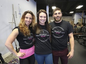 Brooke Maschi, centre, is flanked by Christina and Nick Prevett, owners of Stave Off gym, during a fundraising powerlifting competition. (Meghan Balogh/The Whig-Standard/Postmedia Network)