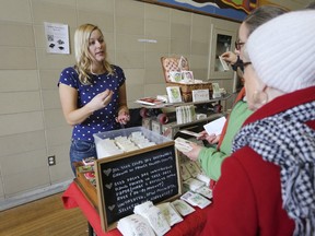 Stacey Hubbs, owner of Edible Antiques, speaks with seed customers at Seedy Saturday at Loyalist Collegiate on Saturday. (Meghan Balogh/The Whig-Standard/Postmedia Network)